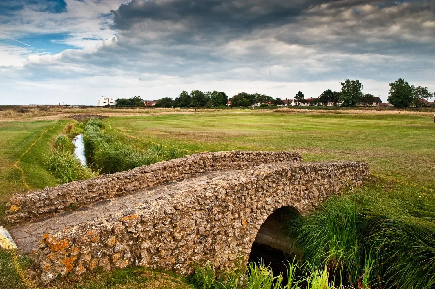 An old stone bridge over the ditch guarding a green at Royal Cinque Ports in Deal, Kent